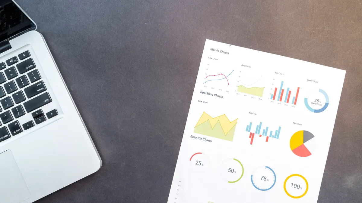 Bing SEO reporting: which metrics to watch every month desk with laptop edge and a printed chart report
